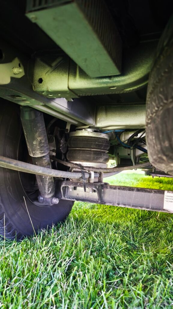 Obrázek zobrazuje podvozek obytného auta, který přehledně ukazuje části systému odpružení.