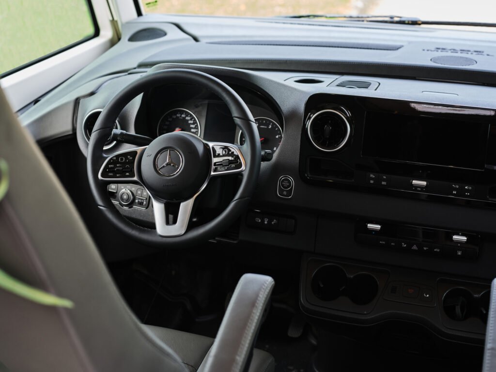 Interiér obytného auta Mercedes s moderním designem a komfortním ovládáním. Ideální pro cestování.