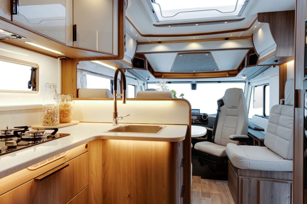 Moderní obytné auto s elegantním interiérem, plně vybavenou kuchyní a pohodlnými sedadly. Ideální pro dobrodružství!