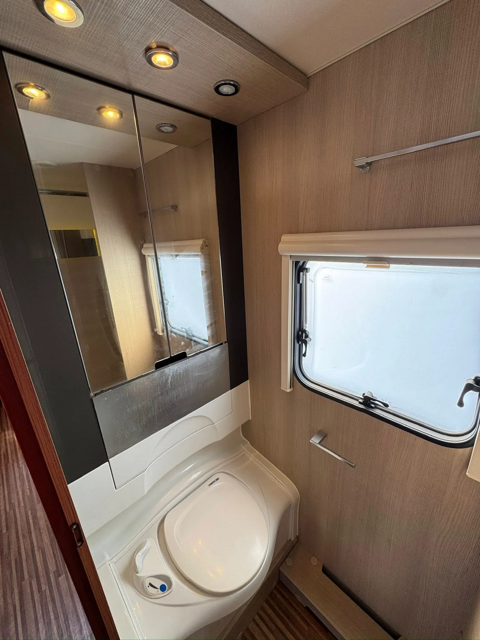 Koupelna v moderním karavanu. Elegance minimalismu s praktickým zázemím pro pohodlí na cestách.