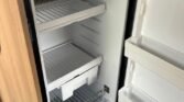 Interiér karavanu - chladnička s dostatkem prostoru pro potraviny a nápoje. Ideální pro cestování.