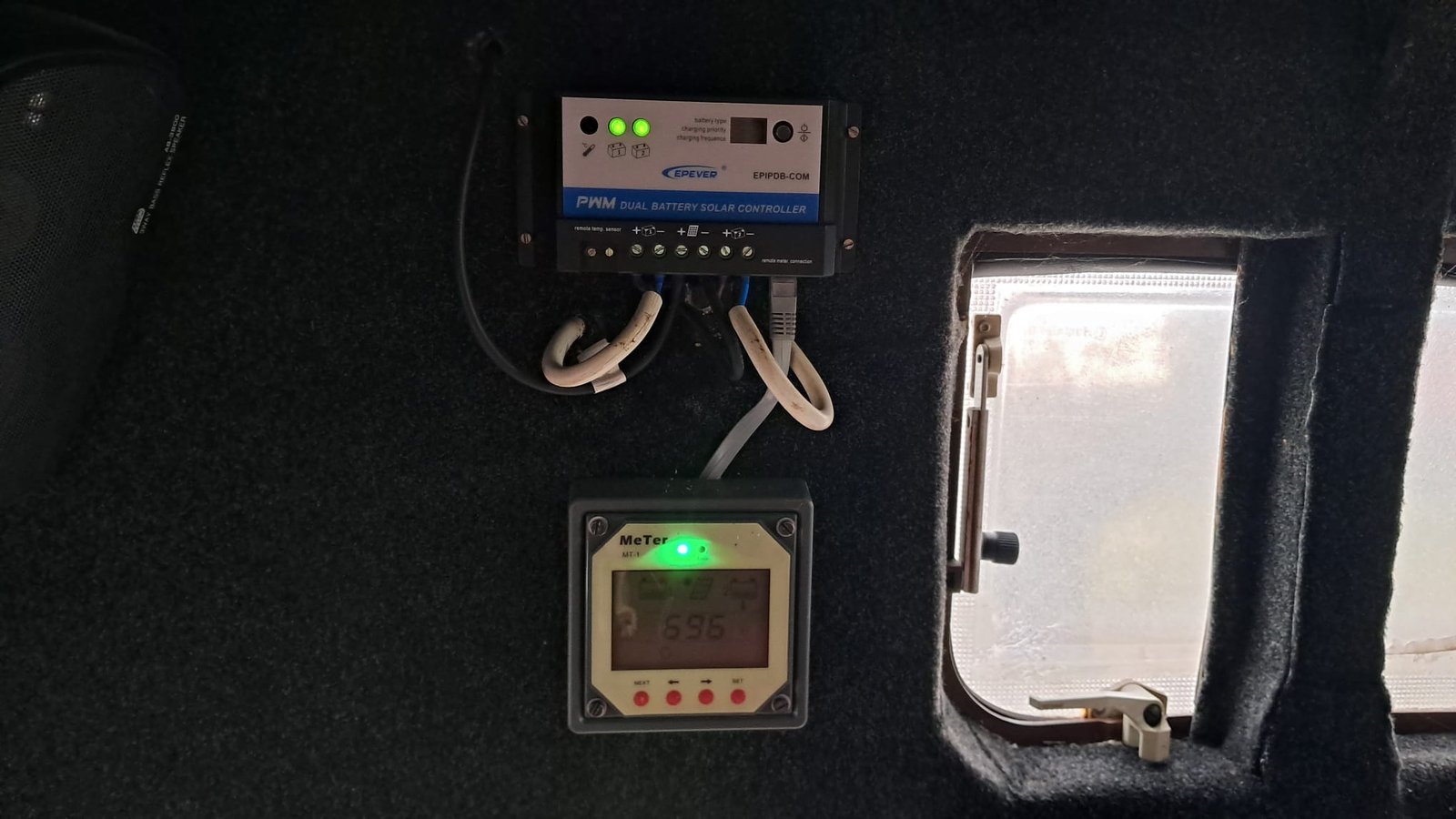 Obrázek zobrazuje regulátor solární energie v interiéru karavanu.