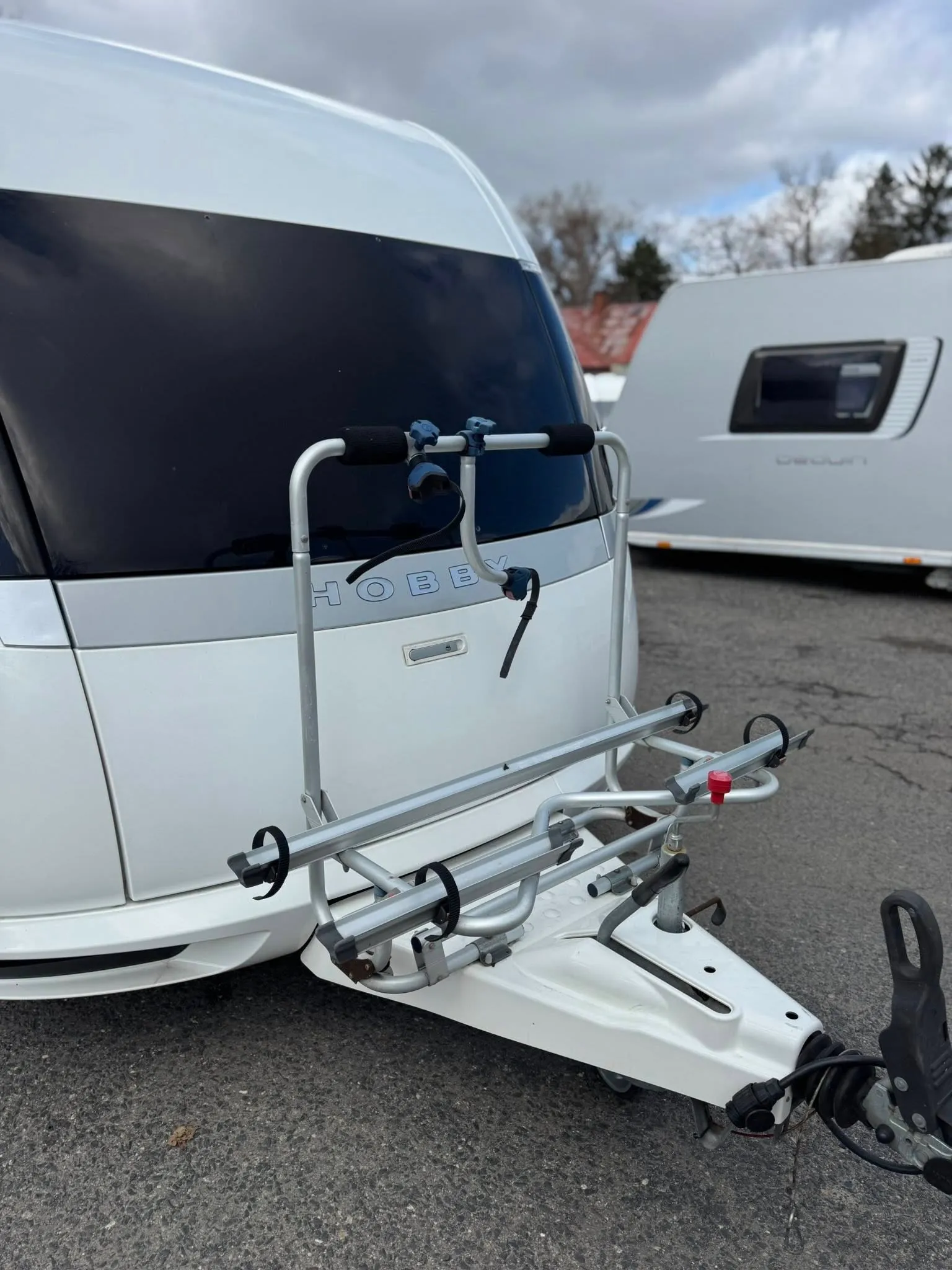 Karavan Hobby s nosičem na kola, ideální pro dobrodružství na cestách.